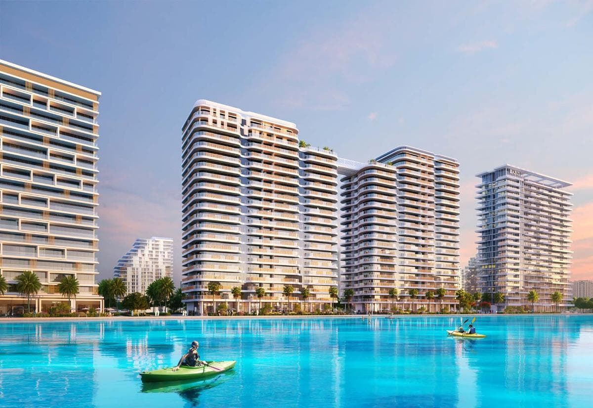 Resort-style infinity pool with palm trees at Azizi Venice waterfront community